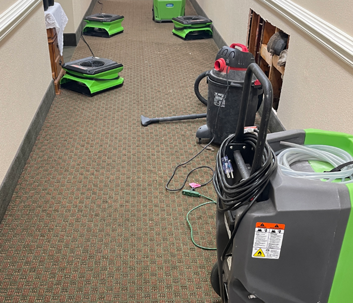 SERVPRO equipment placed in the hallway of a commercial business to dry out water damage.