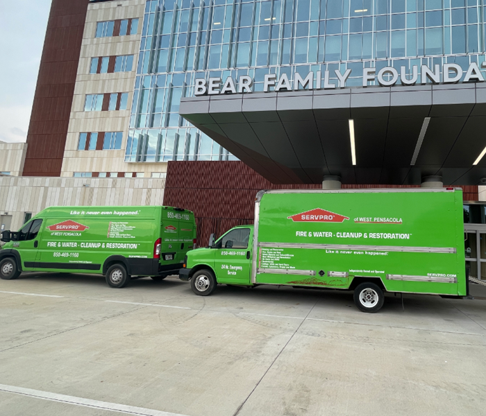 two SERVPRO trucks parked outside of the new Baptist Health Care facility in Pensacola, FL.