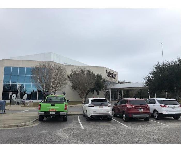 SERVPRO green fleet vehicles in front of a building